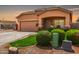 Cozy single-story home boasting a two-car garage, covered porch, and neatly trimmed bushes enhancing the property's appeal at 36064 N Murray Grey Dr, San Tan Valley, AZ 85143