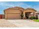 Well-kept single-story residence with a two-car garage, charming covered entry, and simple yet elegant landscaping details at 36064 N Murray Grey Dr, San Tan Valley, AZ 85143