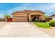 Inviting single-story house with a well-maintained lawn, two-car garage, and a covered porch, offering classic curb appeal at 36064 N Murray Grey Dr, San Tan Valley, AZ 85143