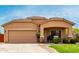 Attractive single-story home showcasing a two-car garage, covered entryway, and manicured landscaping for comfortable living at 36064 N Murray Grey Dr, San Tan Valley, AZ 85143
