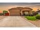 Charming single-story home with a two-car garage, covered porch, manicured lawn, and a spacious driveway in a desirable neighborhood at 36064 N Murray Grey Dr, San Tan Valley, AZ 85143