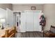 Hallway featuring doors and doorways with a wooden floor and dining table at 36064 N Murray Grey Dr, San Tan Valley, AZ 85143
