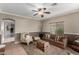 Inviting living room with a comfortable couch, decorative pillows, carpeted floors, and stylish two-tone paint and wainscoting at 36064 N Murray Grey Dr, San Tan Valley, AZ 85143
