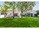 Lush backyard features a well-manicured lawn, outdoor kitchen, and covered patio, perfect for entertaining at 3616 N 54Th Pl, Phoenix, AZ 85018