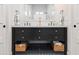 Bathroom with a double sink vanity, black cabinets, and white countertops plus a large mirror and tiled floor at 3616 N 54Th Pl, Phoenix, AZ 85018
