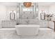 Spa-like bathroom with freestanding tub, marble shower, dual vanities, and elegant fixtures at 3616 N 54Th Pl, Phoenix, AZ 85018