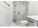 Modern bathroom with glass shower, sleek fixtures, and marble tiling at 3616 N 54Th Pl, Phoenix, AZ 85018
