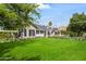 Expansive home with brick and white siding, lush lawn, and mature trees at 3616 N 54Th Pl, Phoenix, AZ 85018