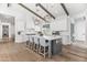 Spacious kitchen boasts white cabinets, a large island, modern lighting, and stainless steel appliances at 3616 N 54Th Pl, Phoenix, AZ 85018