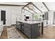 Open kitchen with white cabinets, large island, high-end appliances, and a view of the Gathering room at 3616 N 54Th Pl, Phoenix, AZ 85018