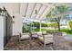 Covered patio boasts a stone floor, comfortable seating, and views of the expansive backyard at 3616 N 54Th Pl, Phoenix, AZ 85018