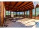 Enclosed patio with wood ceiling and multiple windows offering natural light; shows some need for repair at 3747 S Mammoth Dr, Casa Grande, AZ 85193