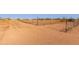Expansive land area with a wire fence, dry vegetation, and a clear blue sky overhead at 3747 S Mammoth Dr, Casa Grande, AZ 85193