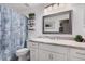 Bright bathroom featuring a vanity with marble countertops and a shower with seashell curtain at 4262 E Sundance Ave, Gilbert, AZ 85297