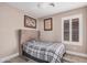 Comfortable bedroom with a plaid bedspread and a window with shutter style blinds at 4262 E Sundance Ave, Gilbert, AZ 85297