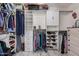 Organized walk-in closet with shelving, drawers, and hanging racks offers ample storage at 4262 E Sundance Ave, Gilbert, AZ 85297