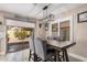 Cozy dining area with modern lighting, gray chairs and a view to the backyard at 4262 E Sundance Ave, Gilbert, AZ 85297