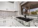 The kitchen area features granite countertops, a black sink and a pull down faucet at 4262 E Sundance Ave, Gilbert, AZ 85297