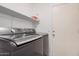 Convenient laundry area featuring modern washer and dryer and shelf for storage at 4262 E Sundance Ave, Gilbert, AZ 85297