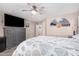 Relaxing main bedroom featuring calming decor, a ceiling fan, and a large TV at 4262 E Sundance Ave, Gilbert, AZ 85297