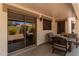 Covered patio with comfortable seating, sliding glass doors, and view of the landscaped backyard at 4262 E Sundance Ave, Gilbert, AZ 85297