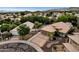 Aerial view of a home and neighborhood with lush landscaping and desert surroundings with mountains in the background at 4616 E Gold Poppy Way, Phoenix, AZ 85044
