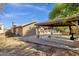 Exterior view of the home, featuring a covered patio and outdoor kitchen area at 4616 E Gold Poppy Way, Phoenix, AZ 85044