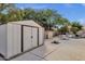 Backyard featuring a storage shed and lush landscaping in addition to the pool at 4616 E Gold Poppy Way, Phoenix, AZ 85044