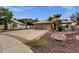 Charming home featuring a tile roof, spacious driveway, and desert landscaping with palm trees at 4616 E Gold Poppy Way, Phoenix, AZ 85044
