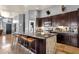 Spacious kitchen with a large island and dark wood cabinetry at 4616 E Gold Poppy Way, Phoenix, AZ 85044