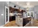 Spacious kitchen with a large island, dark cabinetry, and stainless steel appliances at 4616 E Gold Poppy Way, Phoenix, AZ 85044