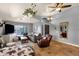 Bright living room showcasing tile floors, a plush grey sofa, and decor at 4616 E Gold Poppy Way, Phoenix, AZ 85044