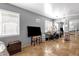 Living room with a TV, a stool, a desk and a mirrored closet at 4616 E Gold Poppy Way, Phoenix, AZ 85044