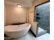 Bright bathroom featuring a modern soaking tub, walk in shower, and updated finishes at 4830 N 72Nd Way, Scottsdale, AZ 85251