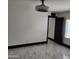Bright room with large windows, shutter shades, overhead fan, and marble floors, complemented by dark trim at 4830 N 72Nd Way, Scottsdale, AZ 85251