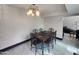 Dining room with tile floors and a stylish light fixture at 4830 N 72Nd Way, Scottsdale, AZ 85251