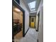 Bright hallway with skylight, laundry area, and distinctive yellow door, offering a cheerful and practical layout at 4830 N 72Nd Way, Scottsdale, AZ 85251