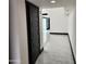 Bright hallway showcases pristine white walls, accentuated by dark trim and sleek marble flooring for a modern look at 4830 N 72Nd Way, Scottsdale, AZ 85251