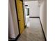 Bright hallway with yellow door and marble floors, offering an inviting transition to the living spaces at 4830 N 72Nd Way, Scottsdale, AZ 85251