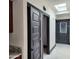 Hallway with skylight, marble floors, dark trim, and doors leading to various rooms, creating a cohesive design at 4830 N 72Nd Way, Scottsdale, AZ 85251
