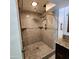 Modern tiled shower featuring glass door, rainfall showerhead, and elegant design at 4830 N 72Nd Way, Scottsdale, AZ 85251