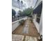 Side yard with a brick paver walkway, desert landscaping, and citrus tree at 4830 N 72Nd Way, Scottsdale, AZ 85251