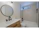 Modern bathroom boasts a decorative mirror, sleek vanity, and walk-in shower with unique tile work at 5627 W Comet Ave, Glendale, AZ 85302
