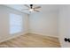 Neutral bedroom featuring a ceiling fan, tile floors, and natural light from a bright window at 5627 W Comet Ave, Glendale, AZ 85302