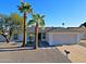 Charming single-story home featuring a well-maintained yard, palm trees, and a two-car garage at 5627 W Comet Ave, Glendale, AZ 85302