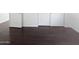 Simple room design with hardwood floors, white doors, and ample floor space at 5976 W Alameda Rd, Glendale, AZ 85310