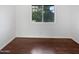 Clean, naturally-lit bedroom featuring hardwood floors and a double-hung window at 5976 W Alameda Rd, Glendale, AZ 85310