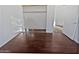 Empty bedroom with hardwood floors, closet and an open doorway to other rooms at 5976 W Alameda Rd, Glendale, AZ 85310