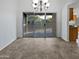 Bright dining area featuring tile floors, sliding glass doors, and a stylish chandelier at 5976 W Alameda Rd, Glendale, AZ 85310