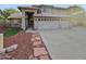 Charming home featuring a three-car garage, desert landscaping, and a tile roof at 5976 W Alameda Rd, Glendale, AZ 85310